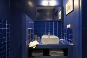 a blue bathroom with a sink and a mirror at Cactus Hydra - Art Apartments in Hydra +53 photos