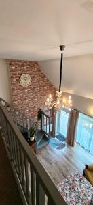 a room with a staircase and a brick wall at Apartament de'Lux in Żywiec