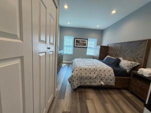 a bedroom with a bed and a wooden floor at Ben house in Baltimore