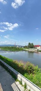 a body of water with a lighthouse in the distance at Apartament de'Lux in Żywiec