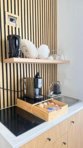 a kitchen with a counter top with a coffee maker in a wooden tray at La Dea Fuoco in Torre del Greco