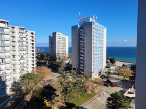 a view of two tall buildings and the ocean at Olimp sea view apartments - 802 in Olimp