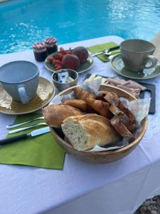a table topped with a plate of bread and pastries at L'Escapade in Cazouls-d Herault
