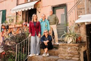 a group of people standing on the stairs of a house at Isabella Boutique Rooms in Levanto
