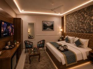a hotel room with a bed and a table and chairs at Hotel Bellamontan Suites Near Delhi Airport - Free Airport Pickup & Drop in New Delhi