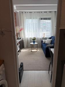 a living room with a blue couch and a window at Apartament Szafir in Gdańsk