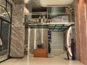 a man standing in a hallway in a building at Hotel Imperial Blu in Similigurha