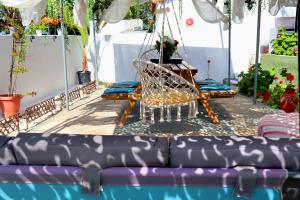 a swing by a swimming pool with a purple couch at La Rosalie in Astris