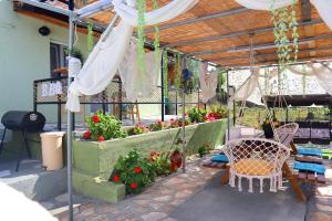 a greenhouse with flowers and a table and chairs at La Rosalie in Astris