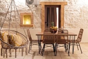 a dining room with a table and chairs at Stone Cottage in Morónion +14 photos