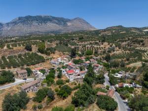 an aerial view of a small town in the mountains at Stone Cottage in Morónion