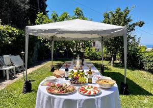 a table with plates of food on a white table cloth at Villa due rami in Anacapri +7 photos