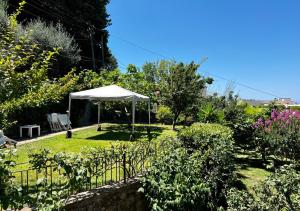 a white tent in a garden with a fence at Villa due rami in Anacapri