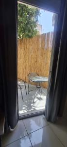a view of a patio with a table and a chair at Alekas Garden View Studios in Kos