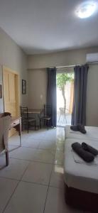 a room with two beds and a table and chairs at Alekas Garden View Studios in Kos +4 photos