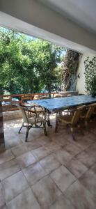 a large picnic table with a blue covering on a patio at Alekas Garden View Studios in Kos