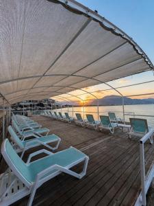 a group of lounge chairs sitting on a dock at Carpe Diem Hotel in Finike