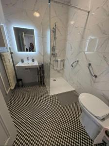 a bathroom with a shower and a toilet and a sink at home santos in Tulle