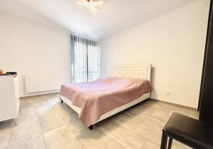 a bedroom with a bed and a ceiling fan at home santos in Tulle