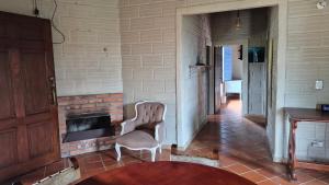 a living room with a chair and a fireplace at Casa campestre in Guarne