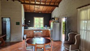 a kitchen with a table and a refrigerator at Casa campestre in Guarne