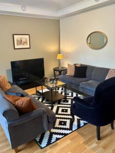 a living room with two couches and a television at Visnes Hotel Stryn in Stryn