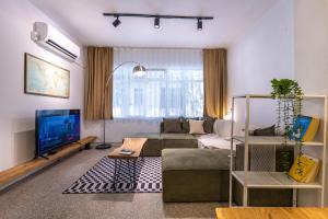 a living room with a couch and a tv at 7a old Marmaris house in Marmaris