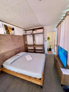 a bedroom with a bed and two bunk beds at Beus home in Durrës