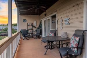 a porch with a table and chairs on it at Mariners Village Tranquil Condo in Seabrook