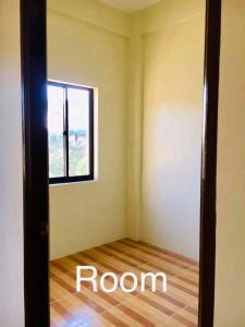 an empty room with a door and a window at Mendoza's Apartment in Tuy
