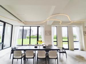 a dining room with a table and chairs at ZJ Villa in Sanxing