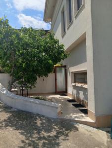 a building with a door and a tree in front of it at Sun Village House 14 in Byala