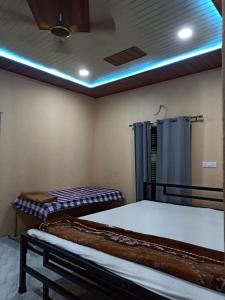 a room with two beds and a shower in it at Shree krishn yatri nivas in Ellora