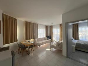a hotel room with a bedroom and a living room at Ivory Serenity in Theologos
