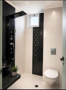 a bathroom with a toilet and a sink at Морски бряг in Pomorie