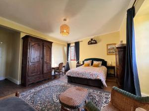 a bedroom with a bed and a dresser in it at Maison du Chapitre in Prudhomat +33 photos
