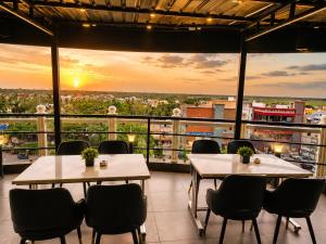 two tables and chairs in a room with a view at Hotel Orion in Bhadrak