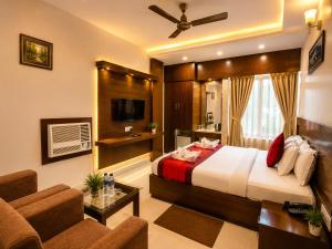 a bedroom with a bed and a living room at Hotel Orion in Bhadrak