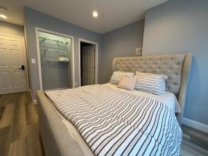 a bedroom with a large bed with a striped comforter at Ben house in Baltimore