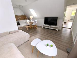 a living room with a couch and a flat screen tv at Ferienwohnung Heide in Walsrode