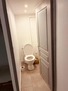 a small bathroom with a toilet and a door at Le Ptit Refuge d'Ay in Ay +11 photos