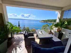 a balcony with a table and a view of the water at Apartments and Rooms Lucia&Veronica in Dramalj
