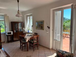 a dining room with a table and chairs and a window at Le Balze in Capannori