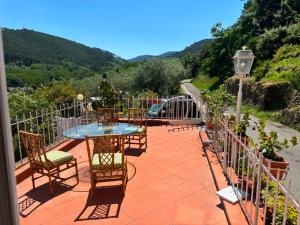 a patio with a table and chairs and a fence at Le Balze in Capannori