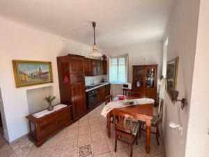 a kitchen with a table and a dining room at Le Balze in Capannori