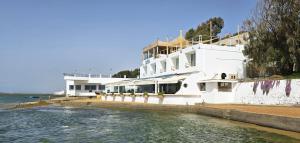a large white building next to the water at Ostrea - Lagune de Oualidia in Oualidia