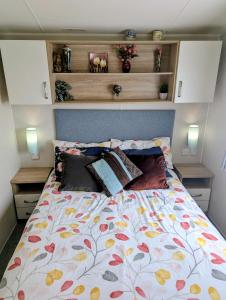 a bed with a floral comforter in a bedroom at 3 bedroom Heaven Home in Chichester +63 photos