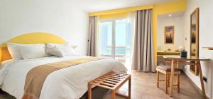 a bedroom with a bed and a table with a desk at Ostrea - Lagune de Oualidia in Oualidia