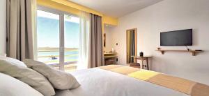 a hotel room with a bed and a television at Ostrea - Lagune de Oualidia in Oualidia