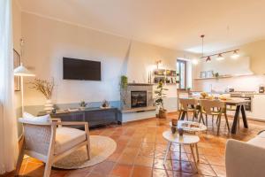a living room with a kitchen and a dining room at Ai due Cedri Appartamento Nocciolo in Capranica